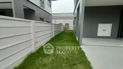 Modern residential exterior with sleek design and green lawn