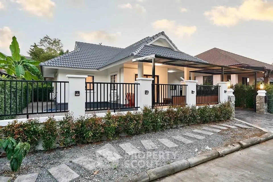 Charming single-story house with modern design and lush garden in a serene neighborhood.