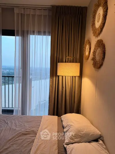 Cozy bedroom with elegant decor and stunning river view from the balcony.