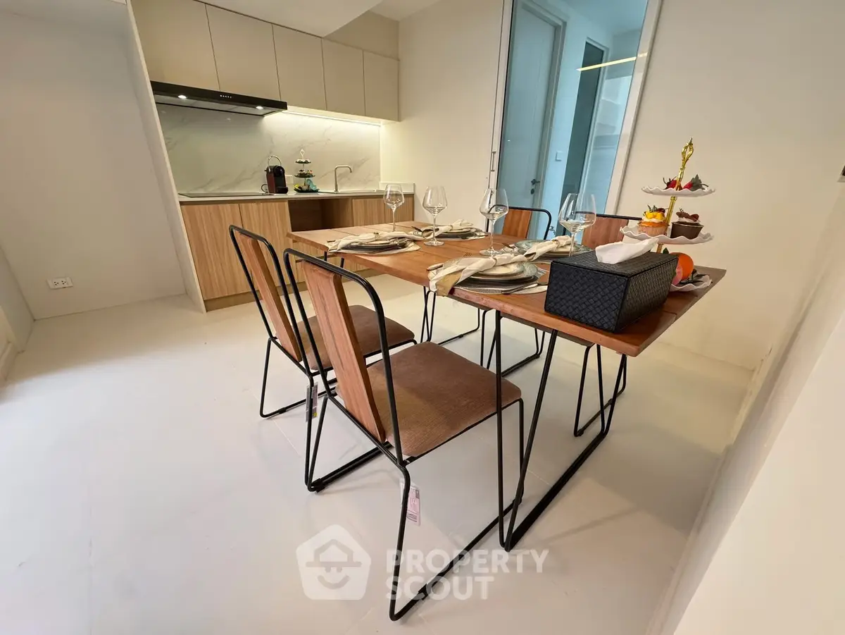 Modern dining area with stylish kitchen and elegant table setting