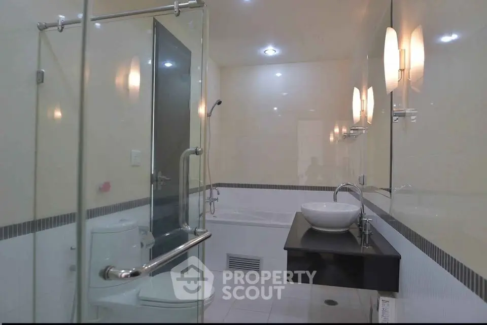 Modern bathroom with glass shower and sleek fixtures