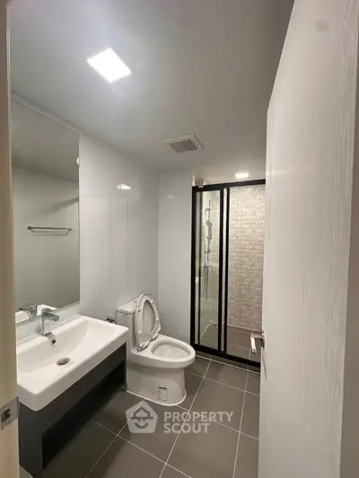 Modern bathroom with sleek fixtures and glass shower enclosure