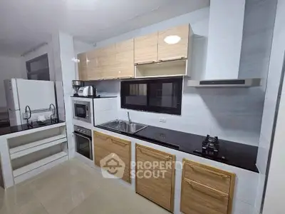 Modern kitchen with sleek cabinetry and built-in appliances, featuring a gas stove and ample counter space.