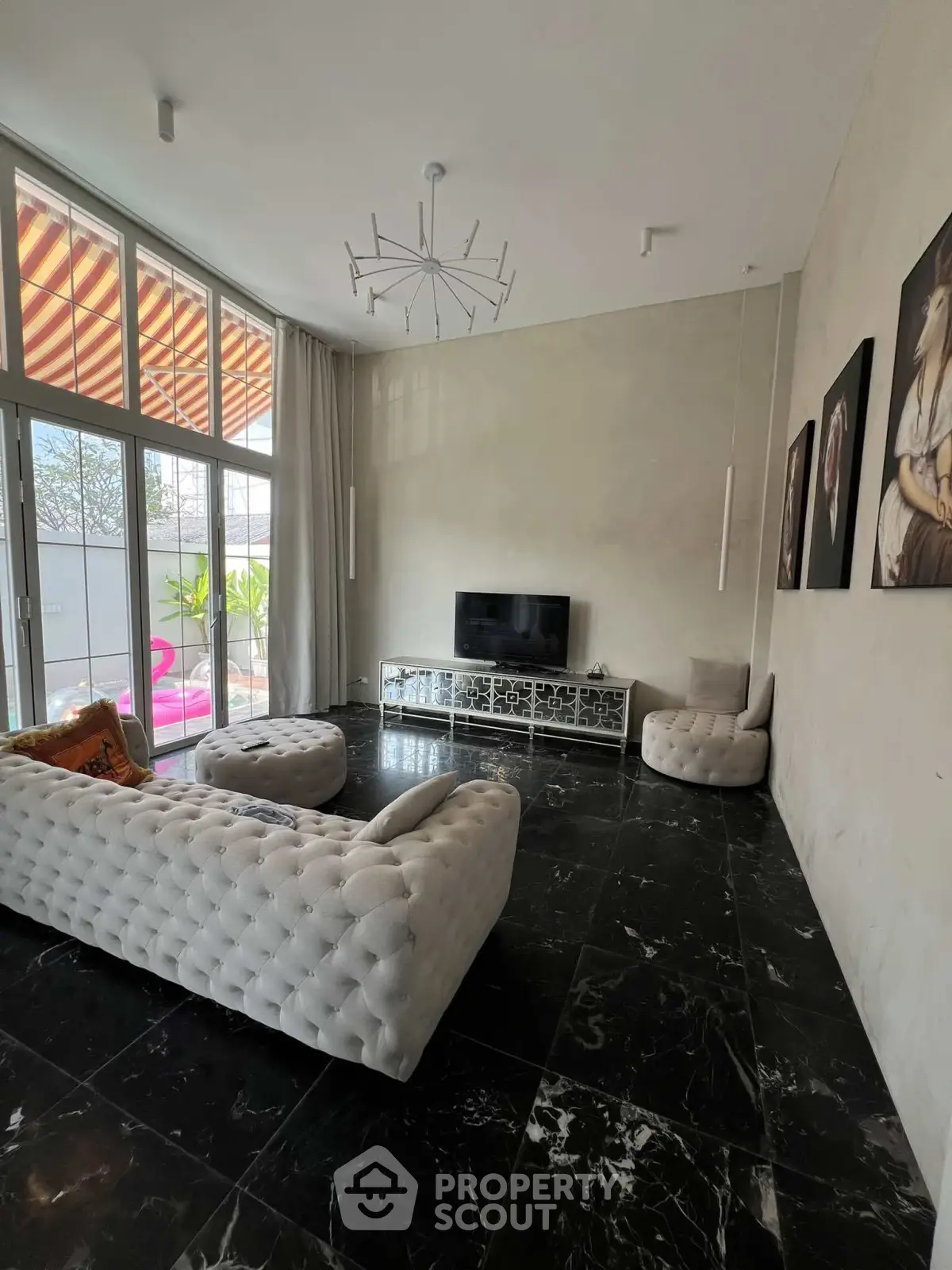 Luxurious living room with modern decor and large windows for natural light.