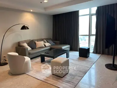 Spacious living room with modern furniture and large window view.