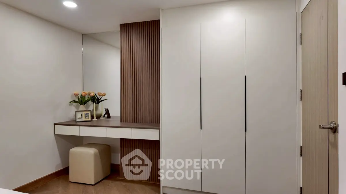 Modern bedroom with sleek wardrobe and stylish vanity area