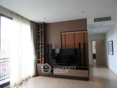 Spacious modern living room with large window and entertainment center