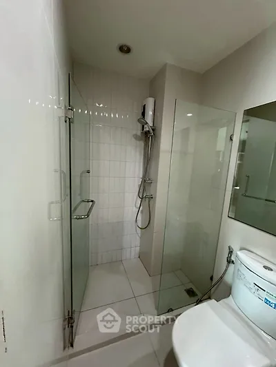 Modern bathroom with glass shower enclosure and sleek fixtures