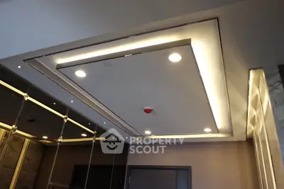 Modern building entrance with sleek ceiling design and recessed lighting