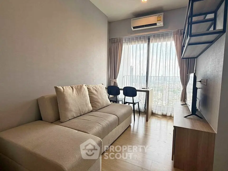 Modern living room with city view, featuring cozy sofa and stylish decor.
