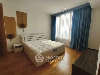 Spacious bedroom with natural light and modern decor in a stylish apartment.