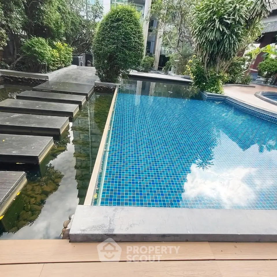 Luxurious outdoor pool with modern design and lush greenery