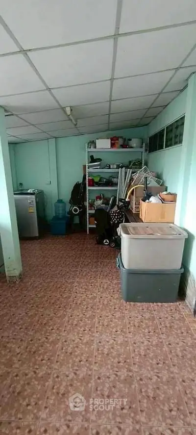 Spacious storage room with tiled floor and organized shelving in a residential property.
