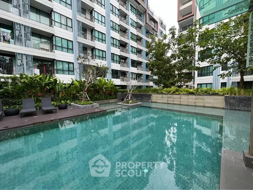 Luxurious condominium with serene swimming pool and lush greenery
