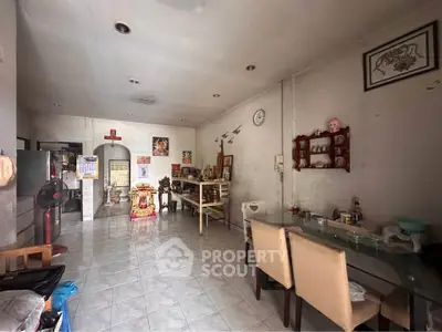Spacious living room with tiled flooring and modern decor, perfect for family gatherings.