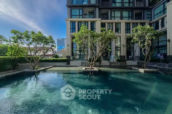 Luxurious residential building with serene pool and lush greenery