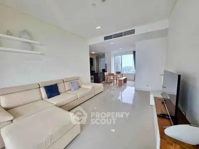 Spacious modern living room with sleek design and city view, perfect for urban living.