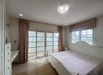 Charming bedroom with elegant decor and large windows for natural light