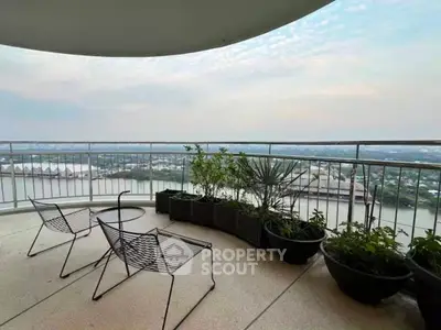 Spacious balcony with stunning river view and modern outdoor seating.
