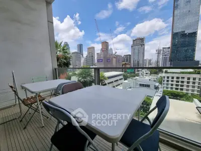 Spacious balcony with city skyline view, perfect for outdoor dining and relaxation.