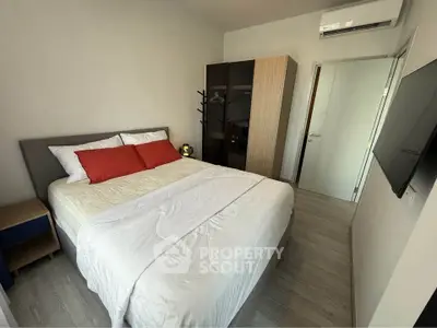 Cozy bedroom with modern furnishings and air conditioning in a stylish apartment.
