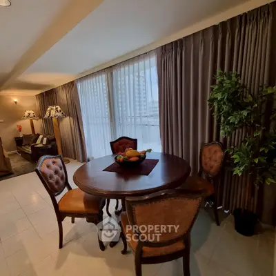 Elegant living room with classic furniture and large windows in a luxurious apartment.