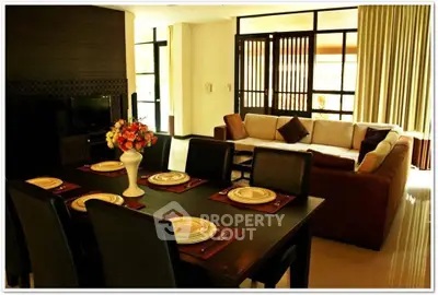 Luxurious living room with elegant dining set and cozy sofa, perfect for entertaining guests.
