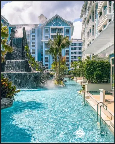 Luxurious resort-style pool with waterfall feature at modern residential complex