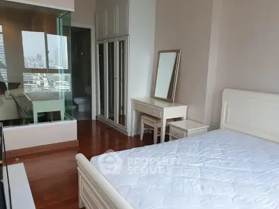 Spacious bedroom with elegant furniture and city view