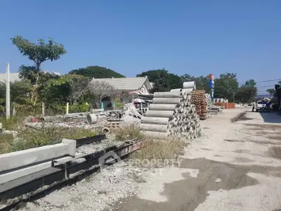 Construction site with stacked concrete pipes and building materials outdoors