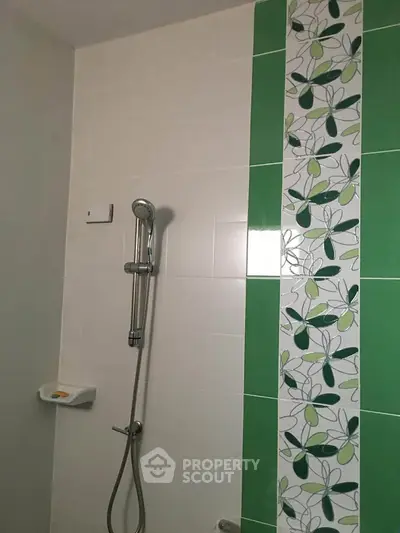 Modern bathroom shower with stylish green and white tile design