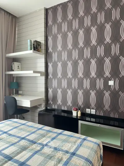 Modern bedroom with stylish wallpaper and cozy workspace