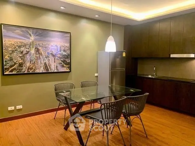 Modern kitchen with glass dining table and sleek cabinetry