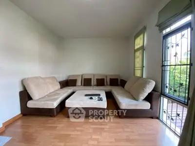 Spacious living room with cozy sectional sofa and large windows for natural light.