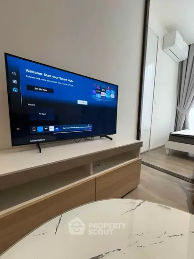 Modern living room with smart TV and stylish decor in a contemporary apartment.