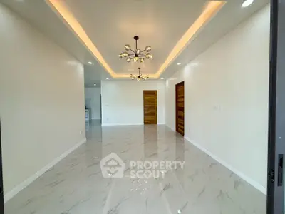 Spacious modern living room with elegant lighting and marble flooring