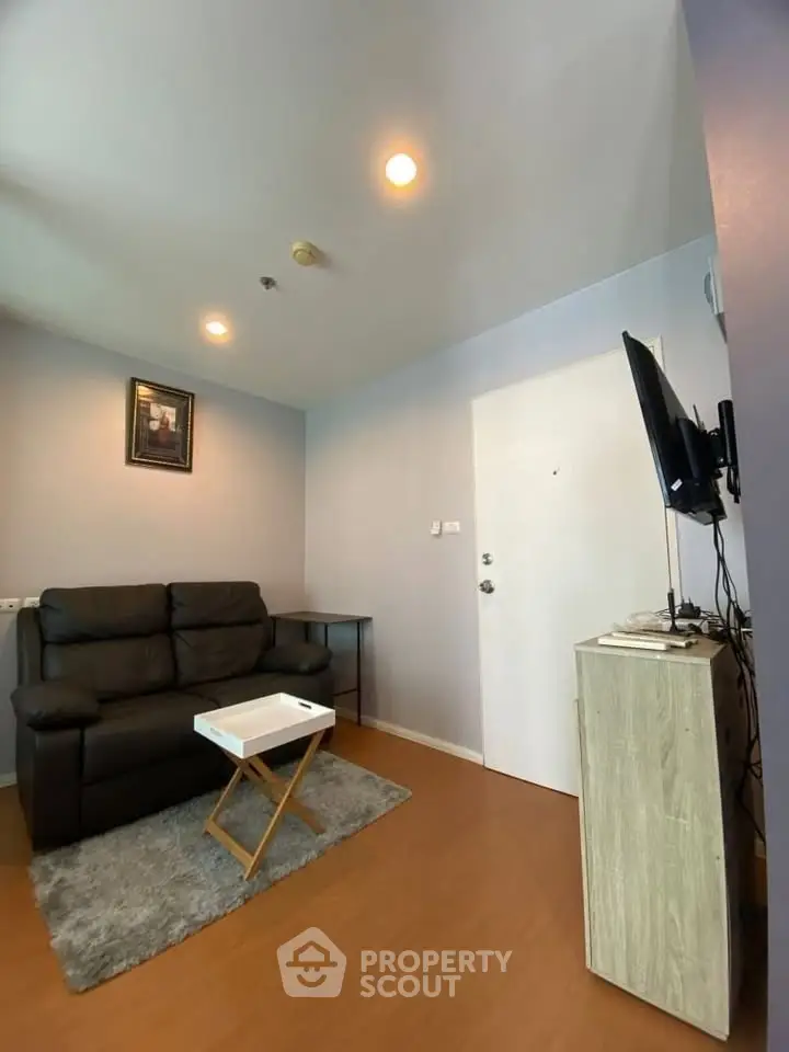 Cozy living room with modern decor and comfortable seating in a stylish apartment.