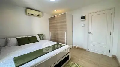 Modern bedroom with sleek wardrobe and air conditioning in a stylish apartment.