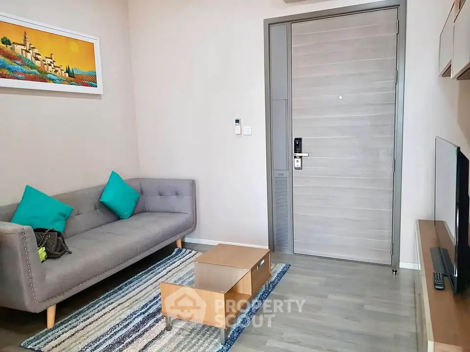 Modern living room with stylish gray sofa, colorful cushions, and sleek wooden coffee table.