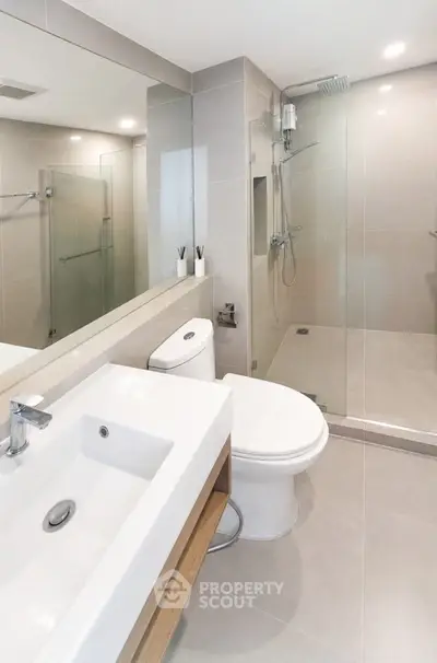 Modern bathroom with sleek fixtures and glass shower enclosure