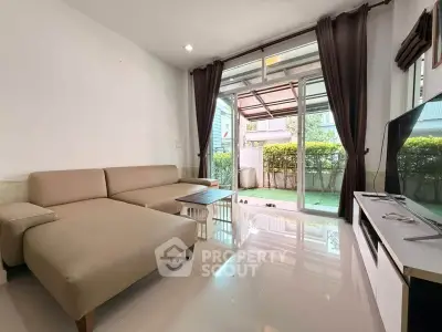 Spacious living room with modern furniture and garden view, perfect for relaxation and entertainment.