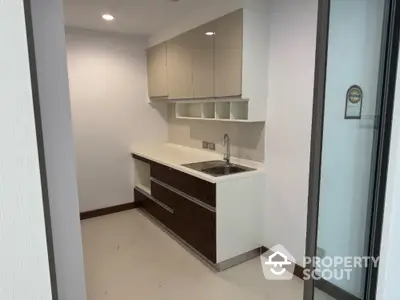 Modern compact kitchen with sleek cabinetry and stainless steel sink