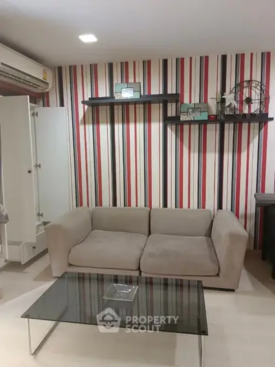 Modern living room with stylish striped wallpaper and cozy beige sofa