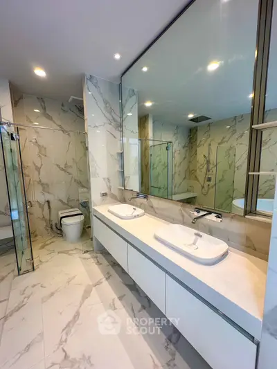 Luxurious modern bathroom with marble tiles and dual sinks