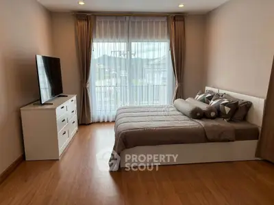 Spacious bedroom with modern decor and large window view