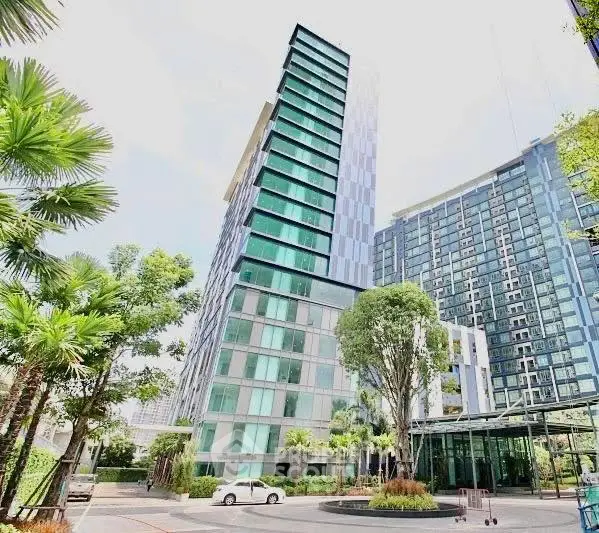 Modern high-rise building with lush greenery and sleek architecture