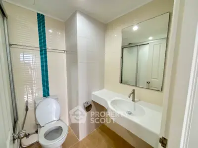 Modern bathroom with sleek design and large mirror in a contemporary home.