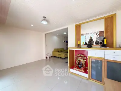 Spacious living room with modern decor and ample natural light