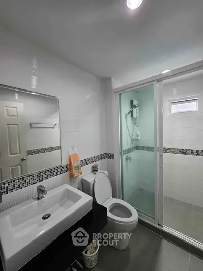 Modern bathroom with sleek fixtures and glass shower enclosure
