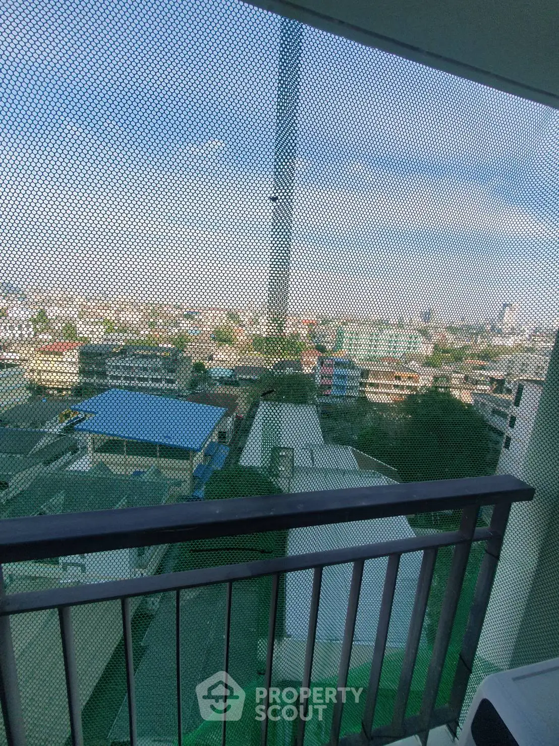 Stunning cityscape view from a high-rise balcony with expansive skyline.